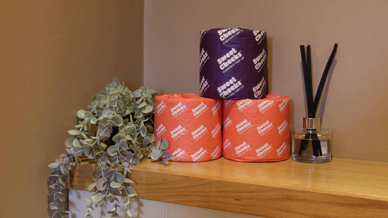 Sugarcane toilet rolls, 3-ply and 5-ply, on a washroom shelf