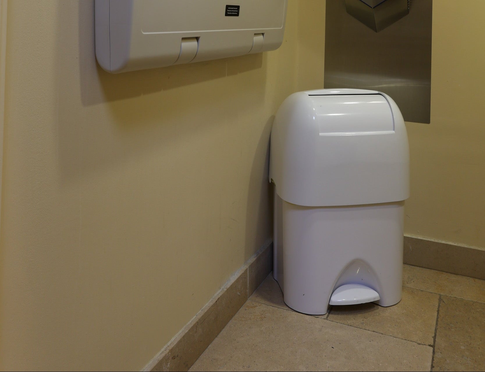 Nappy disposal bin in white fitted in a public washroom