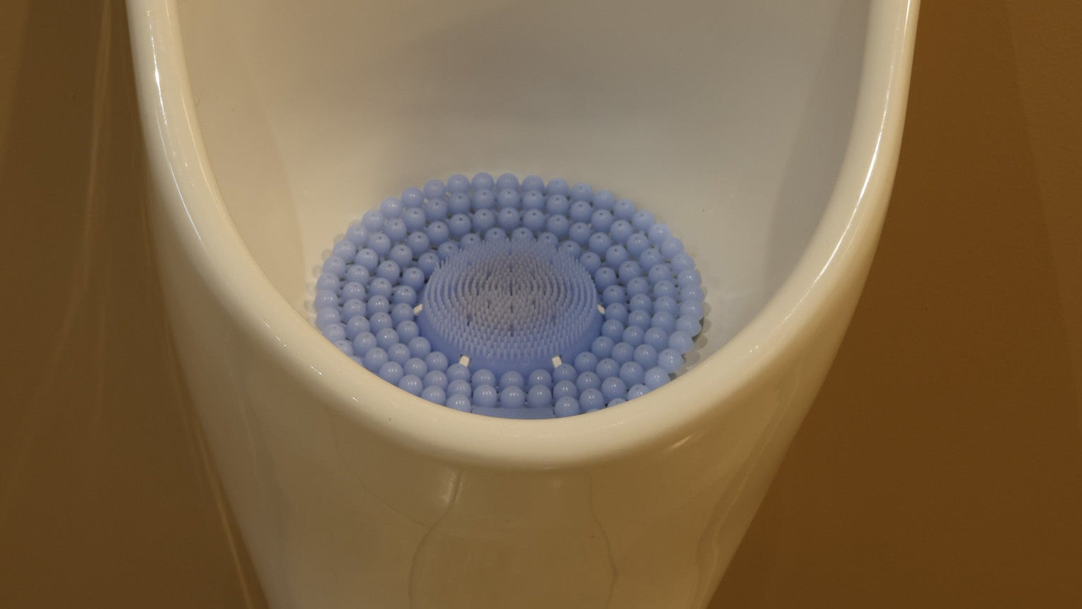 Urinal P screen in Linen Breeze fitted in a clean urinal