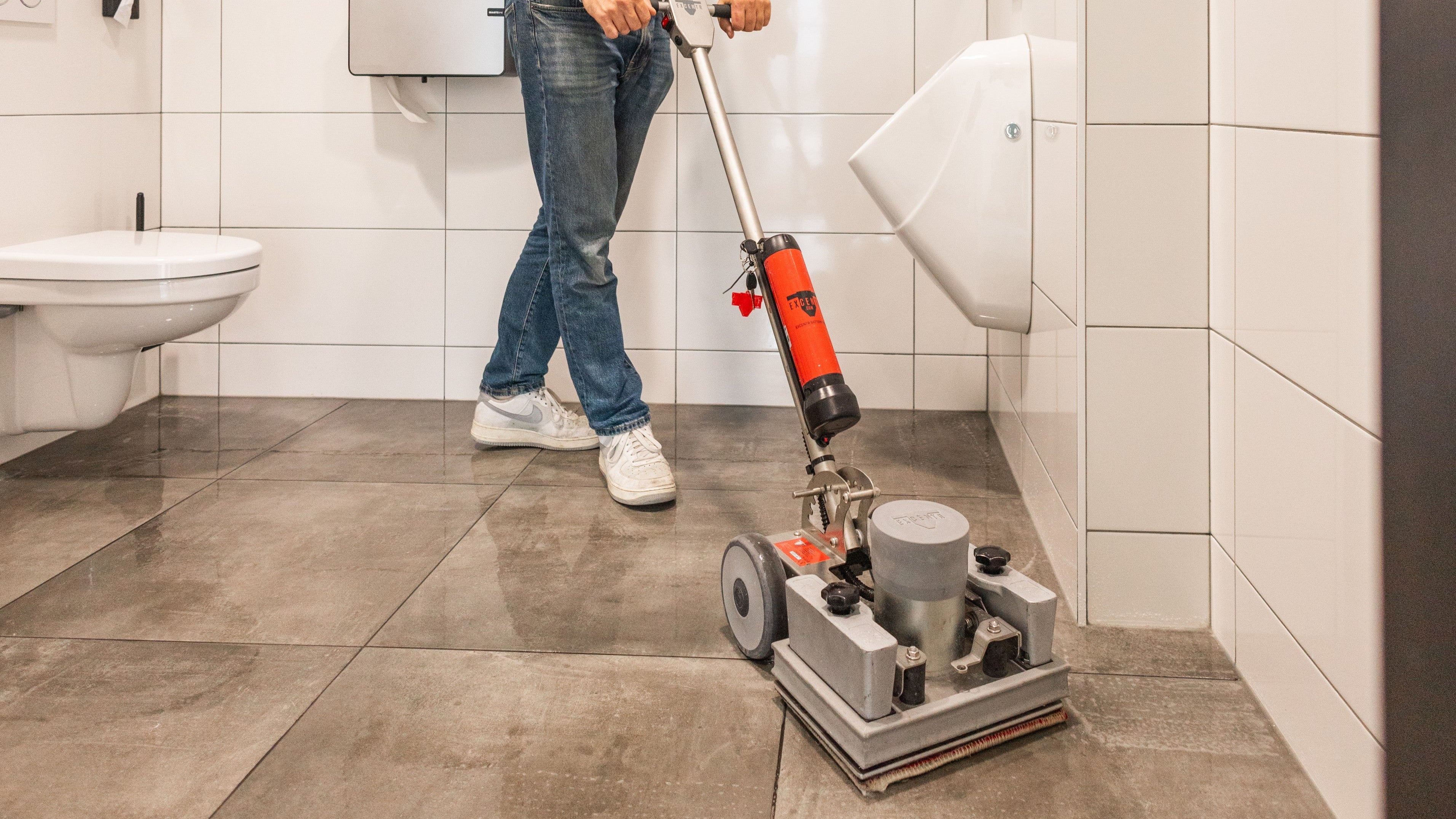 Floor deep clean: OrbiMax machine cleaning a washroom floor