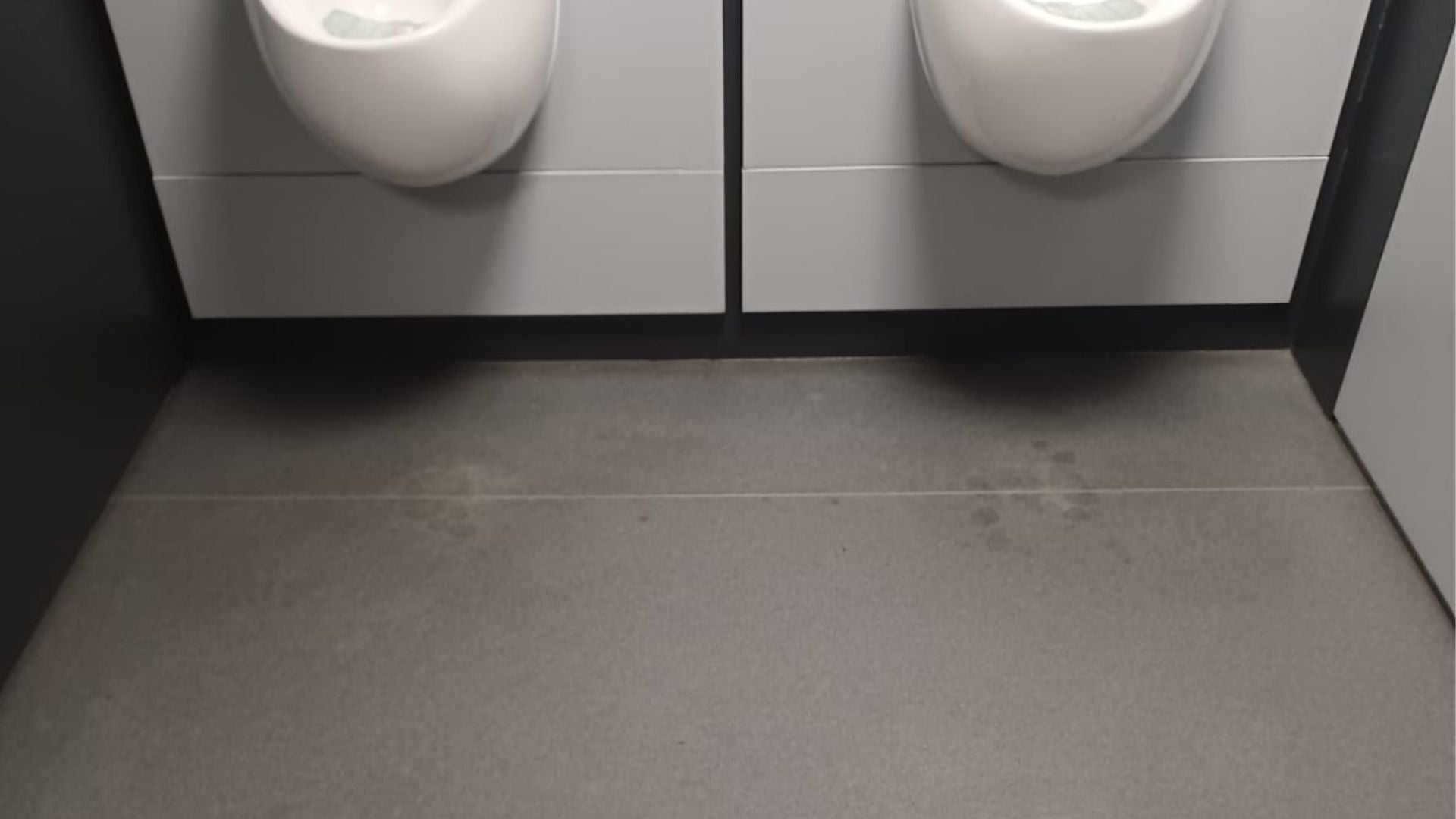 Washroom floor before a deep clean, showing staining