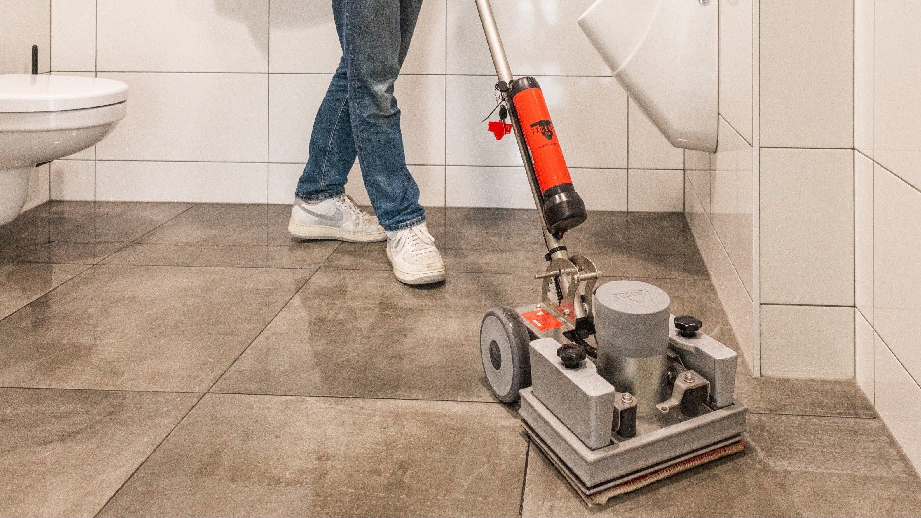 Floor deep clean: OrbiMax machine being used on a washroom floor