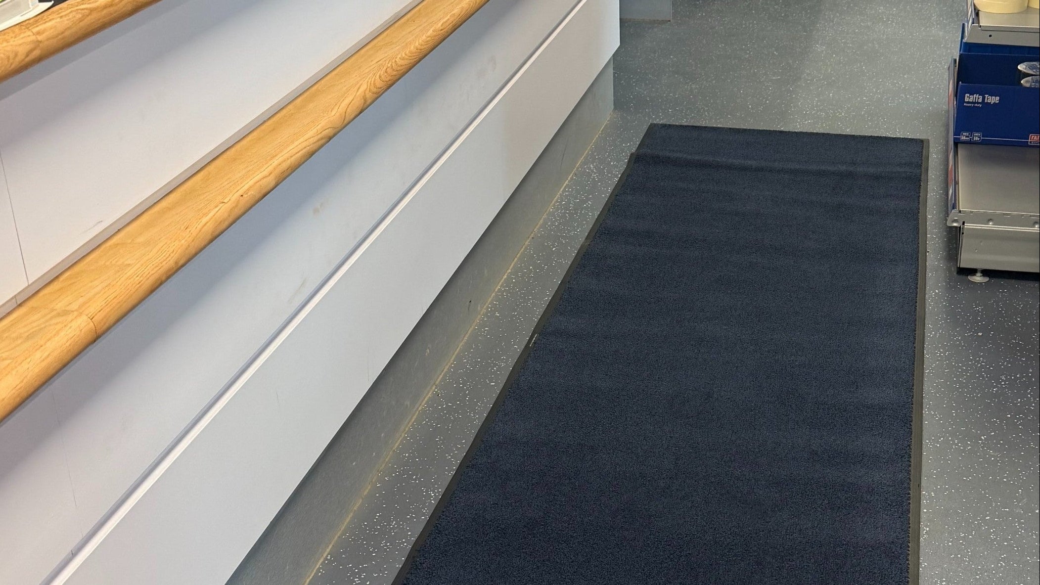 Traffic mats: black mat fitted to a building's entrance layout