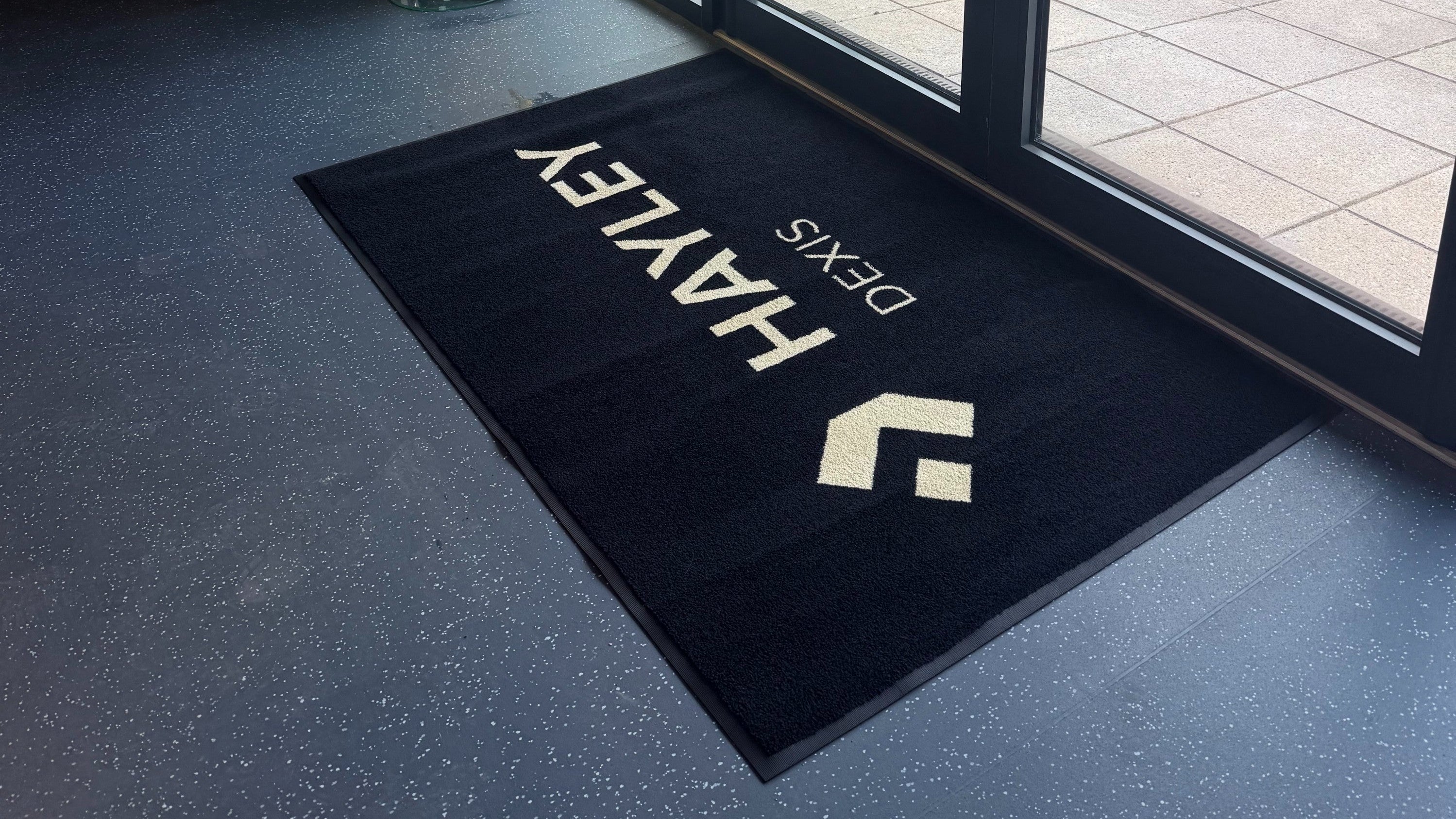 Logo mats: Branded entrance mat inside a commercial building