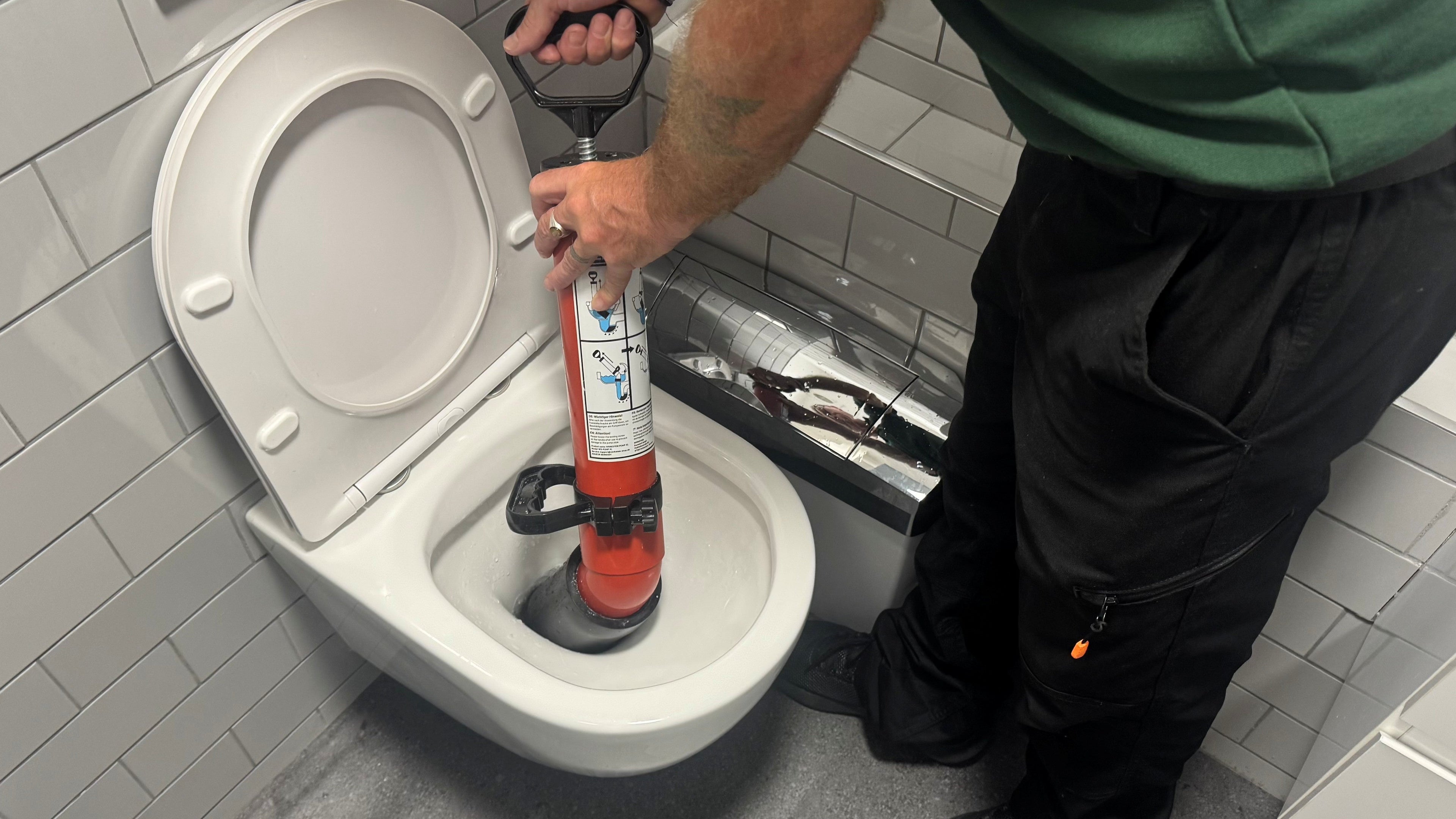 WC deep clean: an engineer deep cleaning a toilet