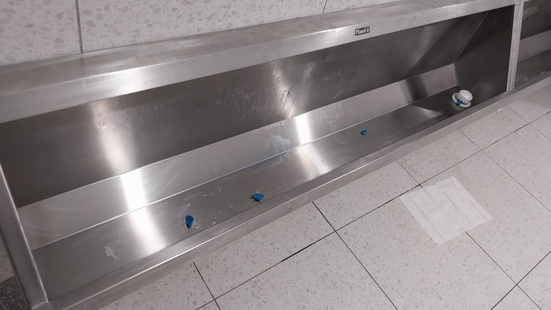 Trough before a deep clean, showing staining