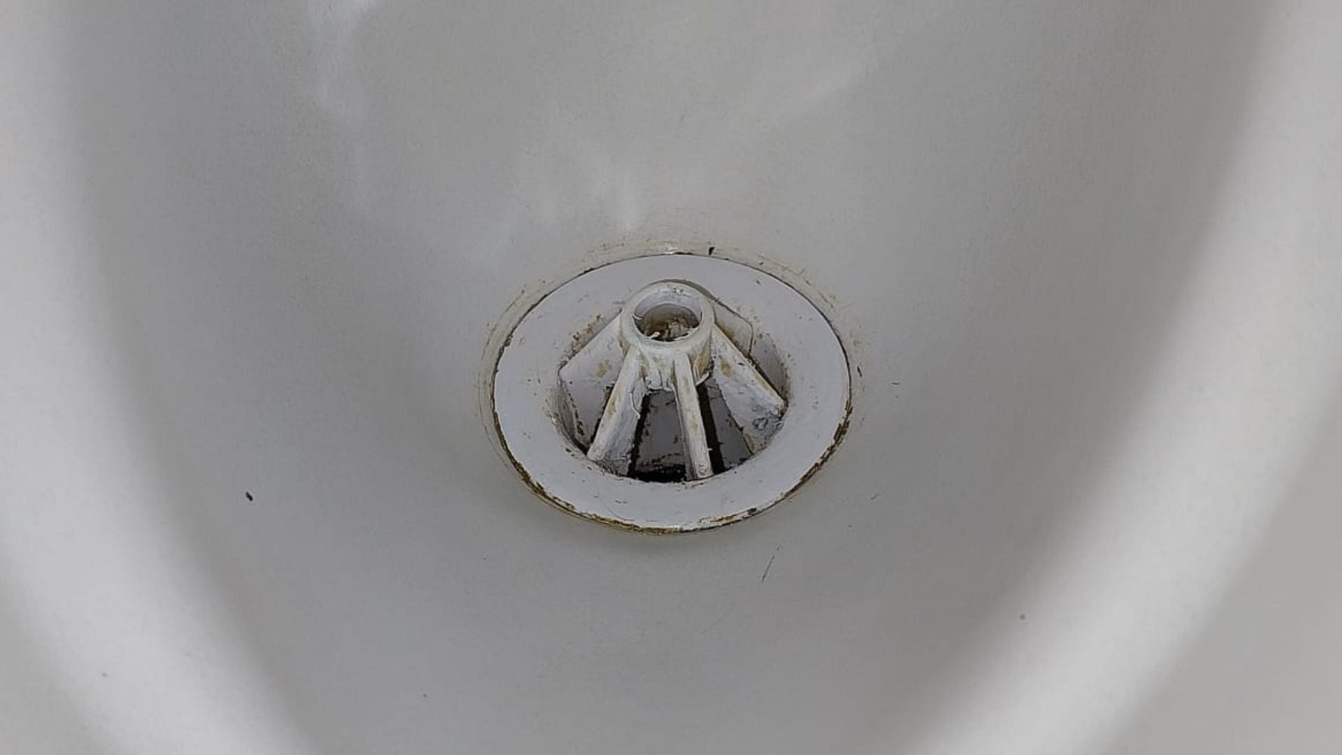 Urinal after a deep clean, showing a clean finish