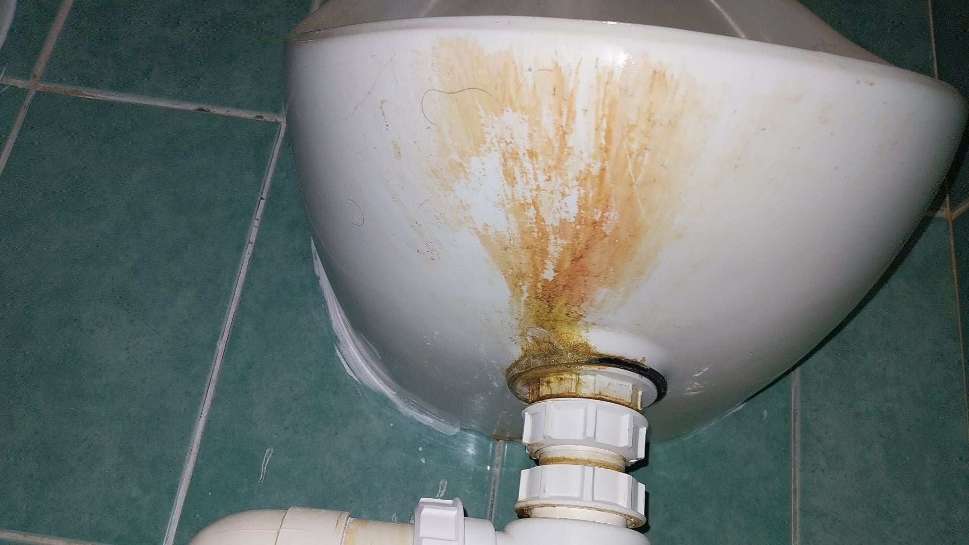 Urinal before a deep clean, showing stains and build up