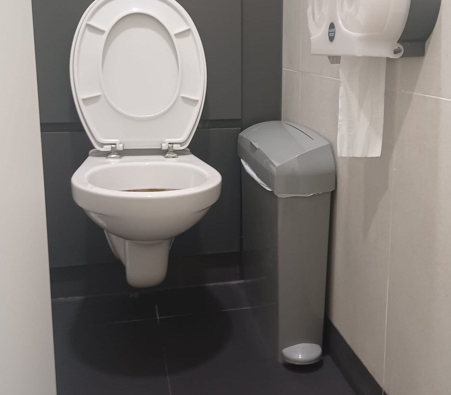 Male healthcare disposal bin fitted in a WC cubicle