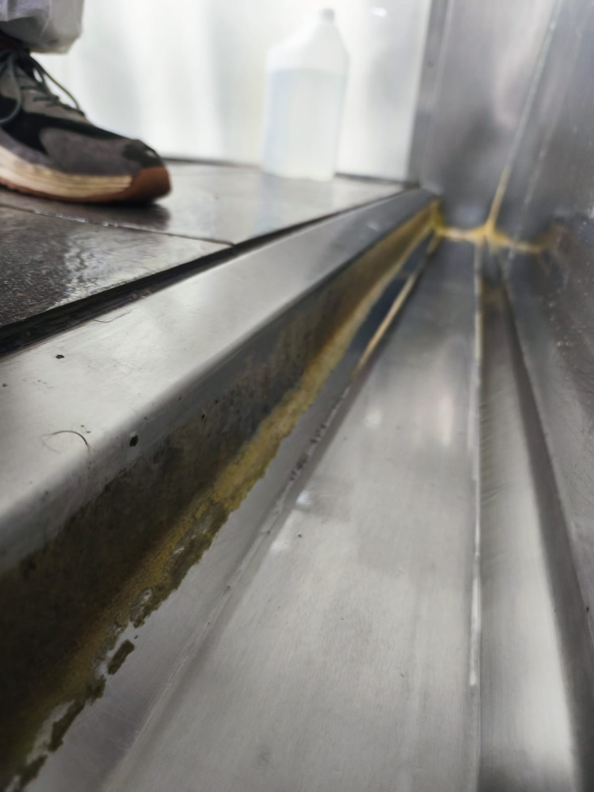 Trough before a deep clean, showing heavy soiling
