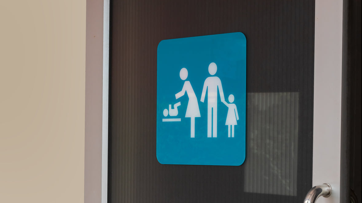 Nappy disposal: family washroom sign on a public washroom door
