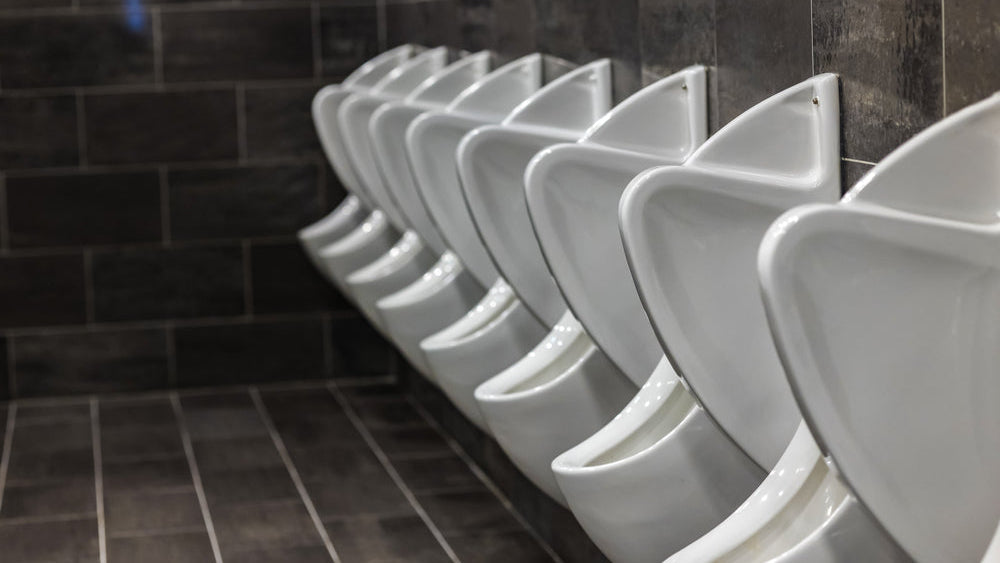 Urinal P screens: white urinals in a public men's washroom