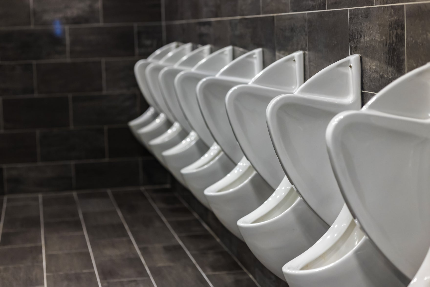 Water saving systems: porcelain urinals in a modern men's washroom
