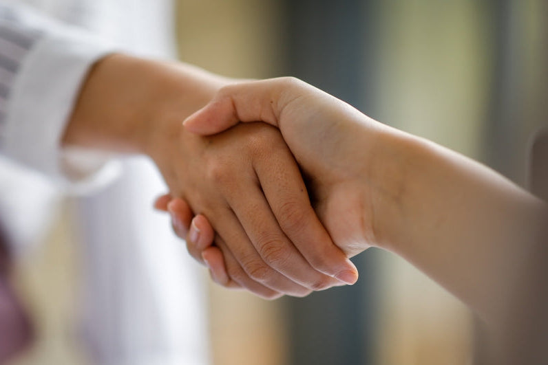 Personal, responsive service: two colleagues shaking hands