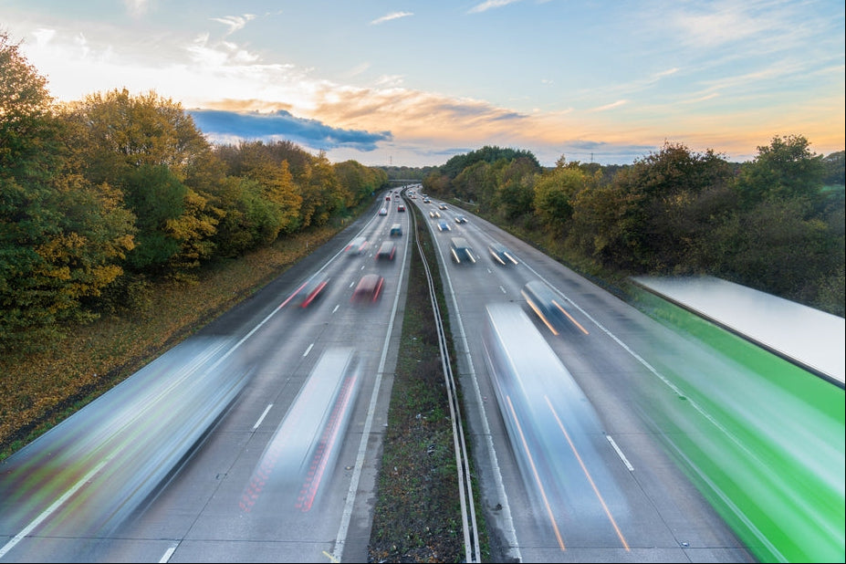 National reach: traffic moving along a UK motorway at sunset