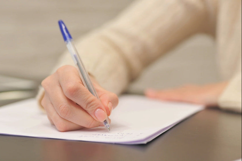 Tailored washroom solutions: a person writing notes on paper