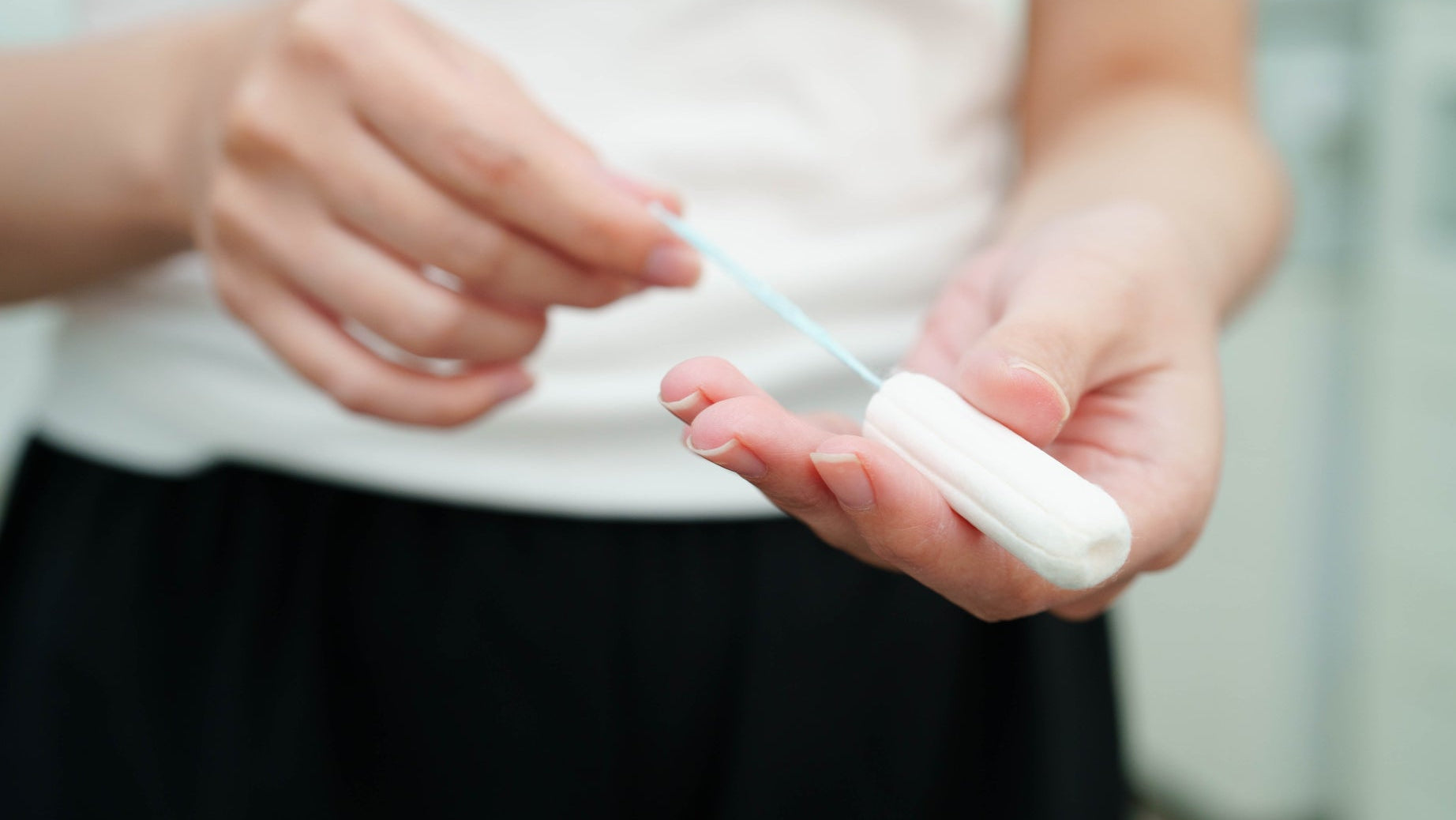 Free vending: a woman holding cotton tampons for period protection
