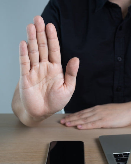 Anti-Bribery and Corruption Policy: a hand raised to refuse a bribe