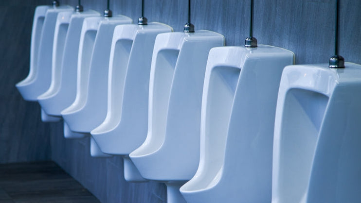 Urinal deep clean: a row of urinals in a modern men's washroom