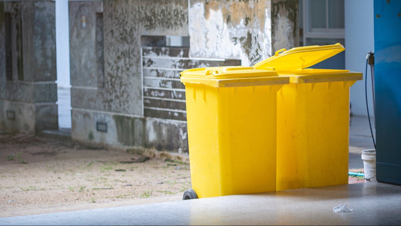 Skip disposal: two 360 litre wheelie skips in an outdoor setting