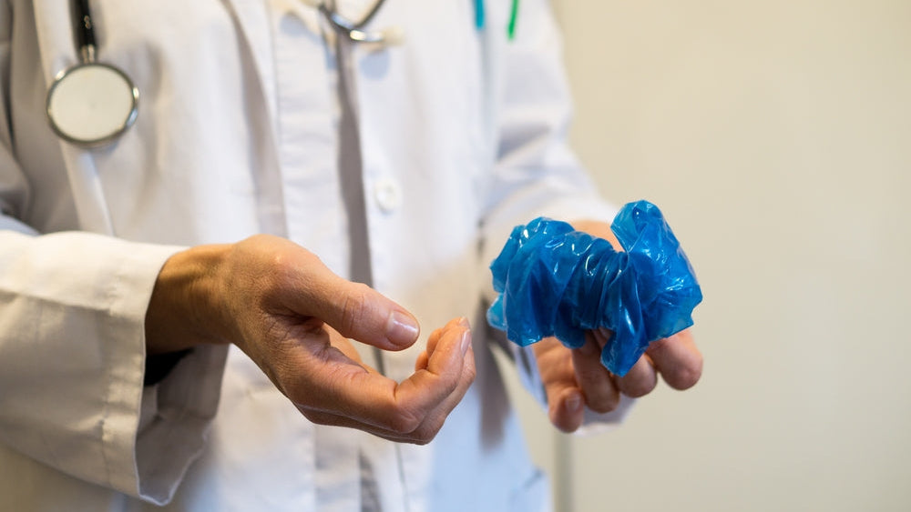 Medical disposal: a doctor demonstrating safe PPE waste management