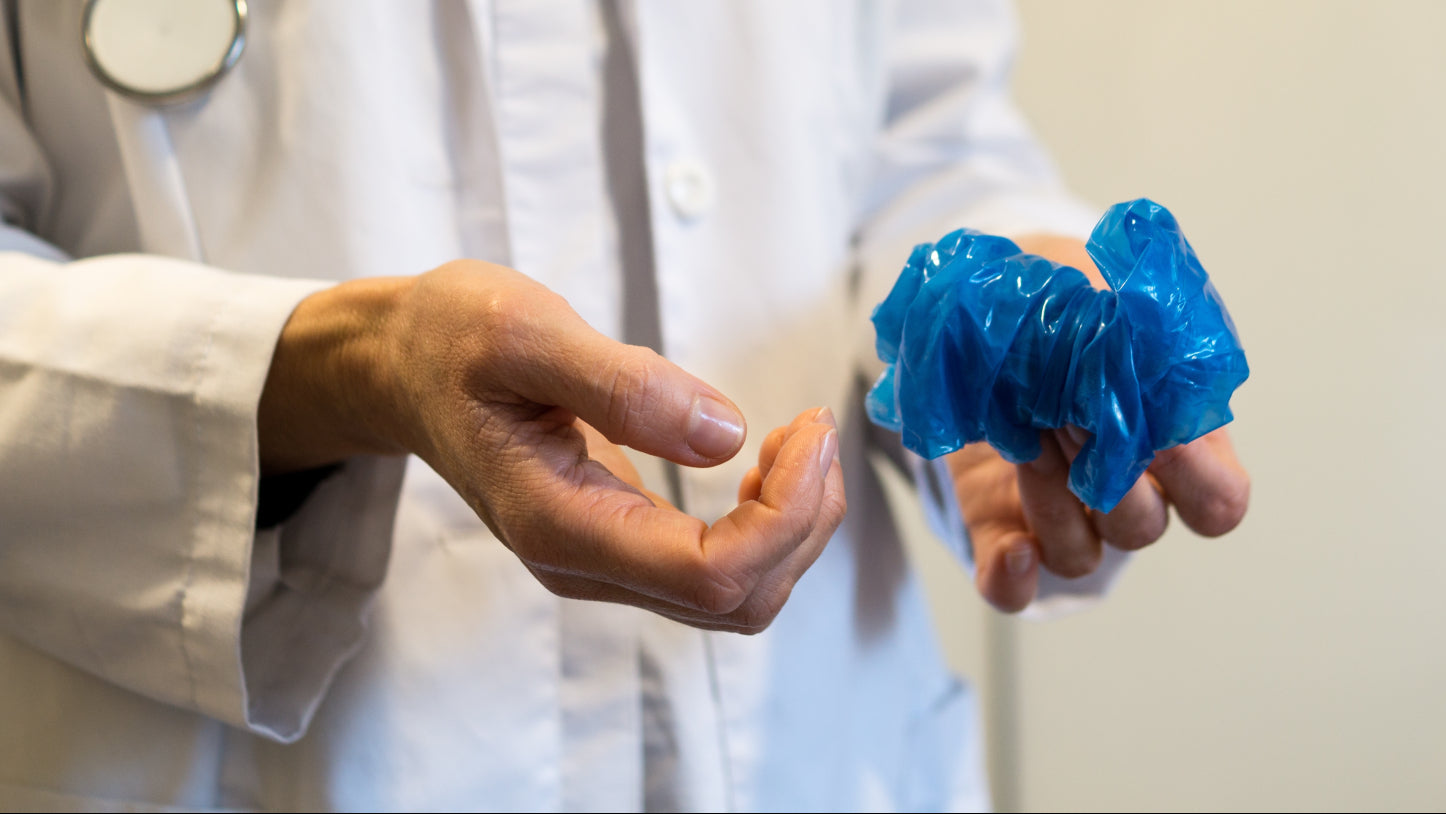 Medical waste disposal: a doctor removing used gloves for safe disposal