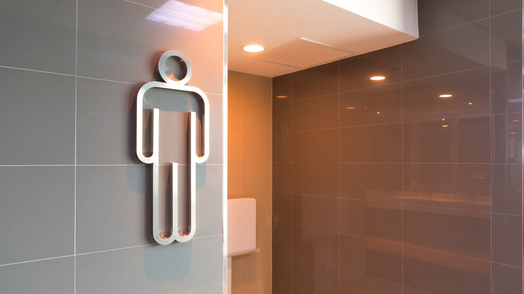 Male healthcare disposal: men's washroom signage at the entrance